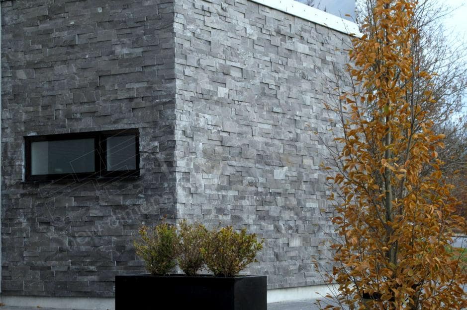 Norstone Charcoal XL Stone Veneer Panel used on the side exterior wall of a modern designed residential home on Long Island